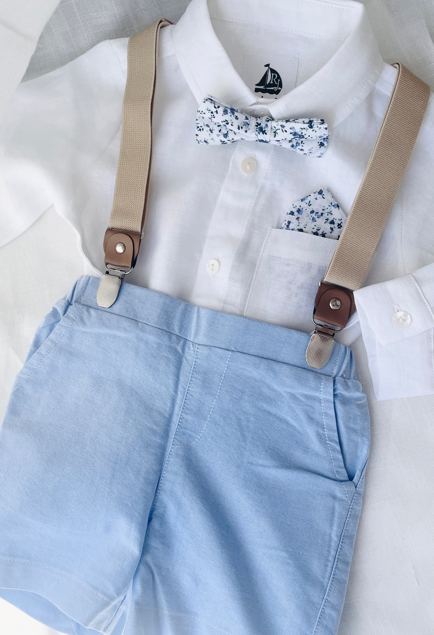 Blue chambray set with blue pants, white linen shirt, white suspenders and blue bowtie