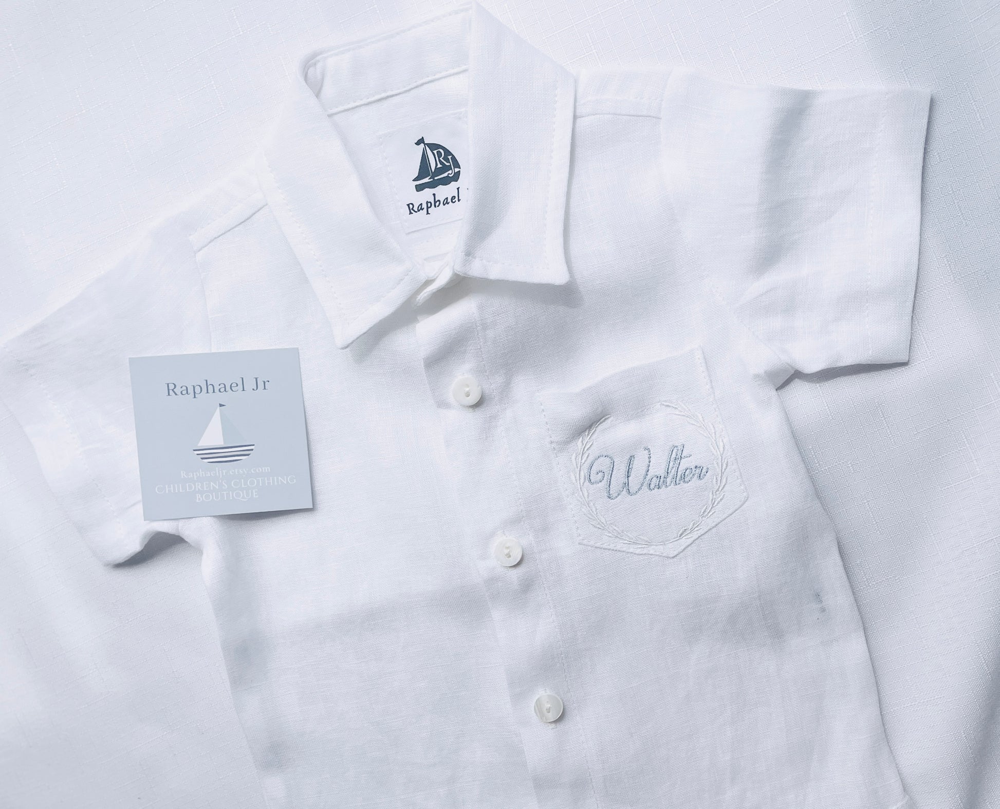 walter written in pale blue thread with white border style number 1 on a short sleeved shirt