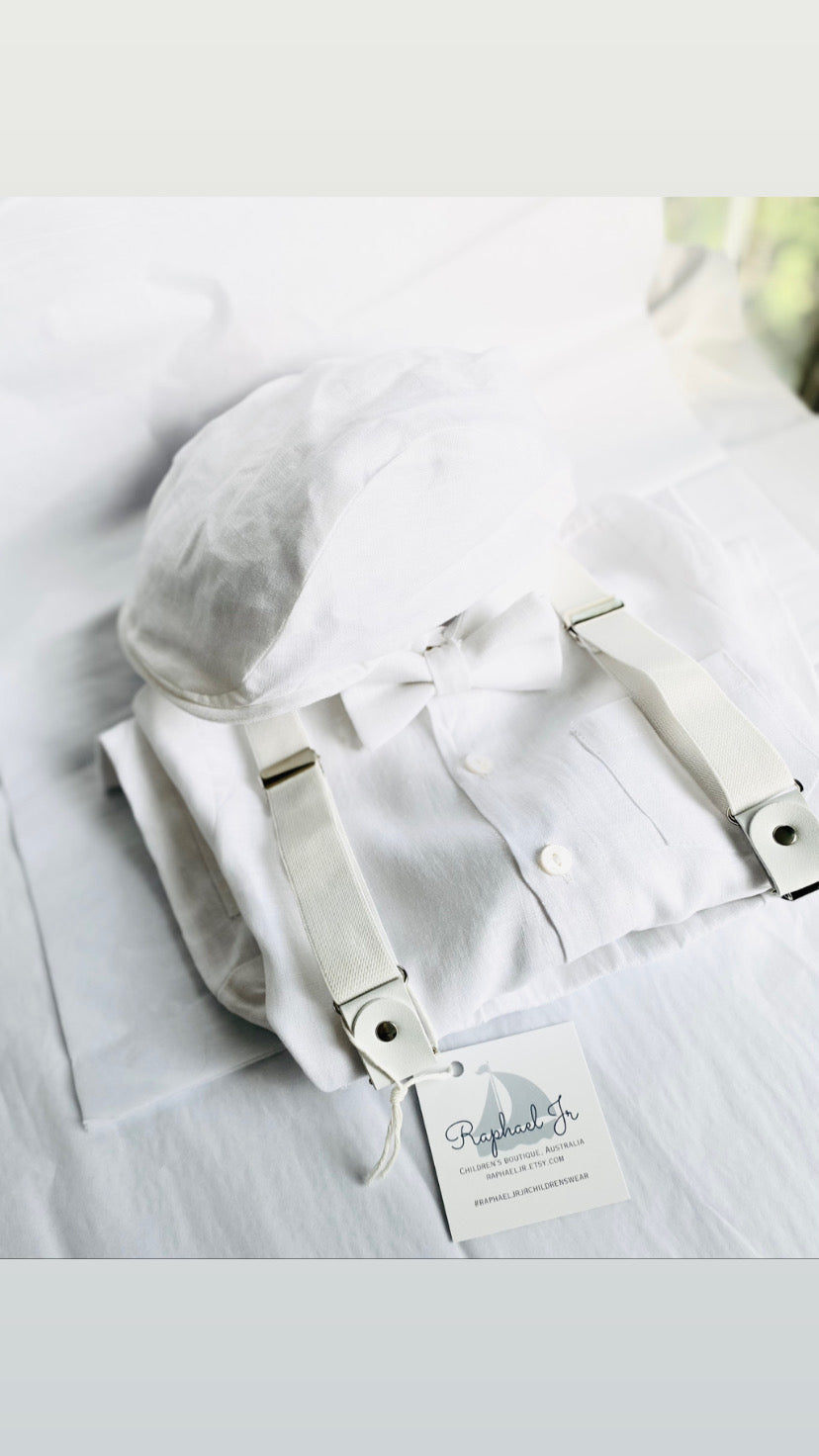 White linen shirt, pants, and white bowtie, White linen flat cap, white suspenders.