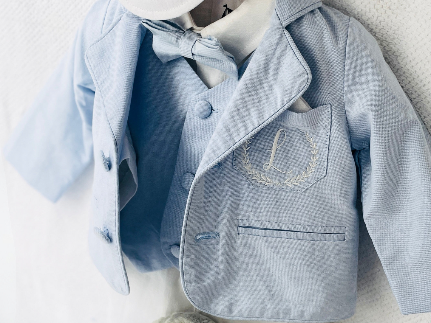 Light blue and white suit set with blue vest, bow tie and jacket, white linen pants, suspenders and shirt