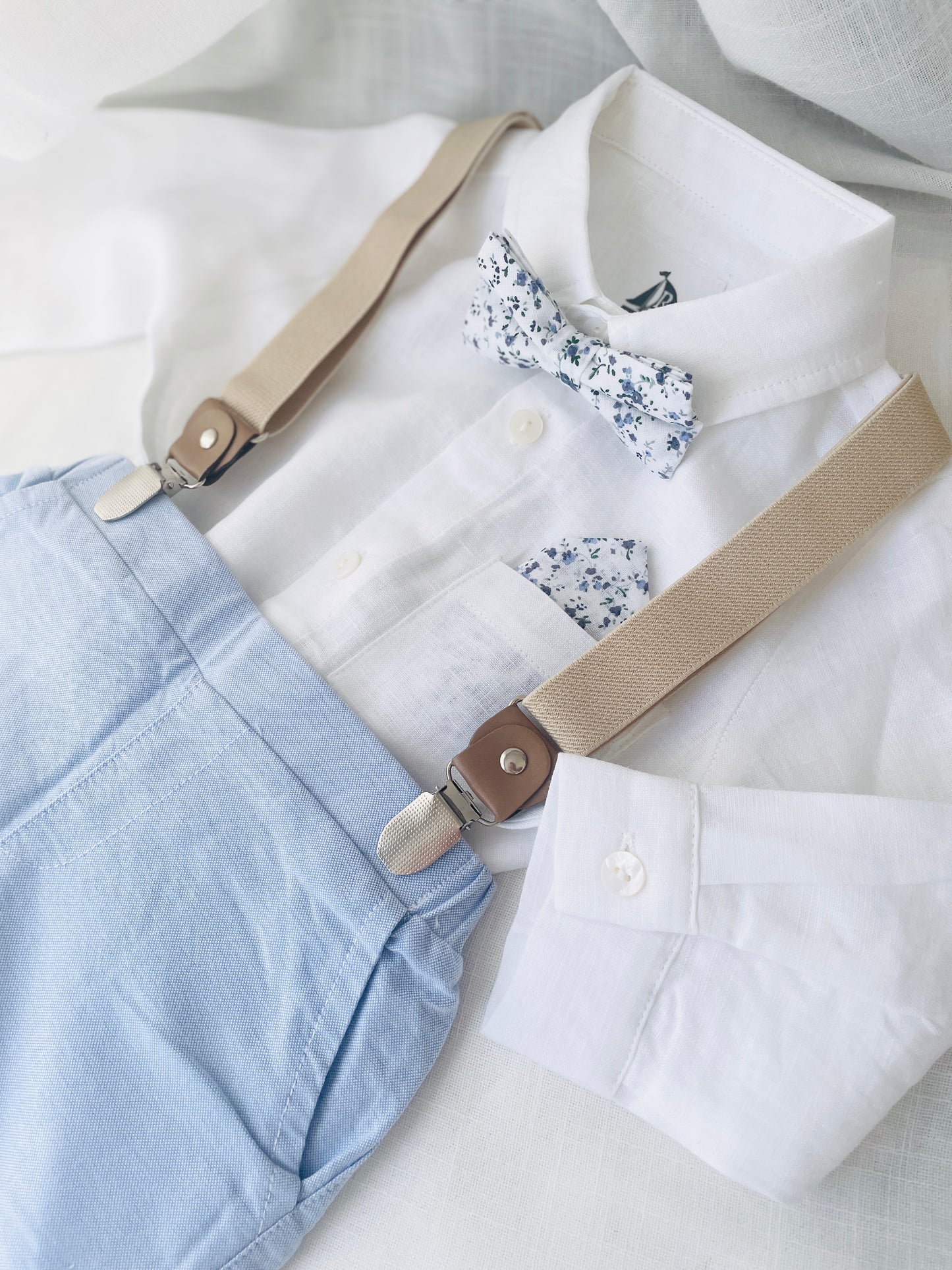 Blue chambray set with blue pants, white linen shirt, white suspenders and blue bowtie