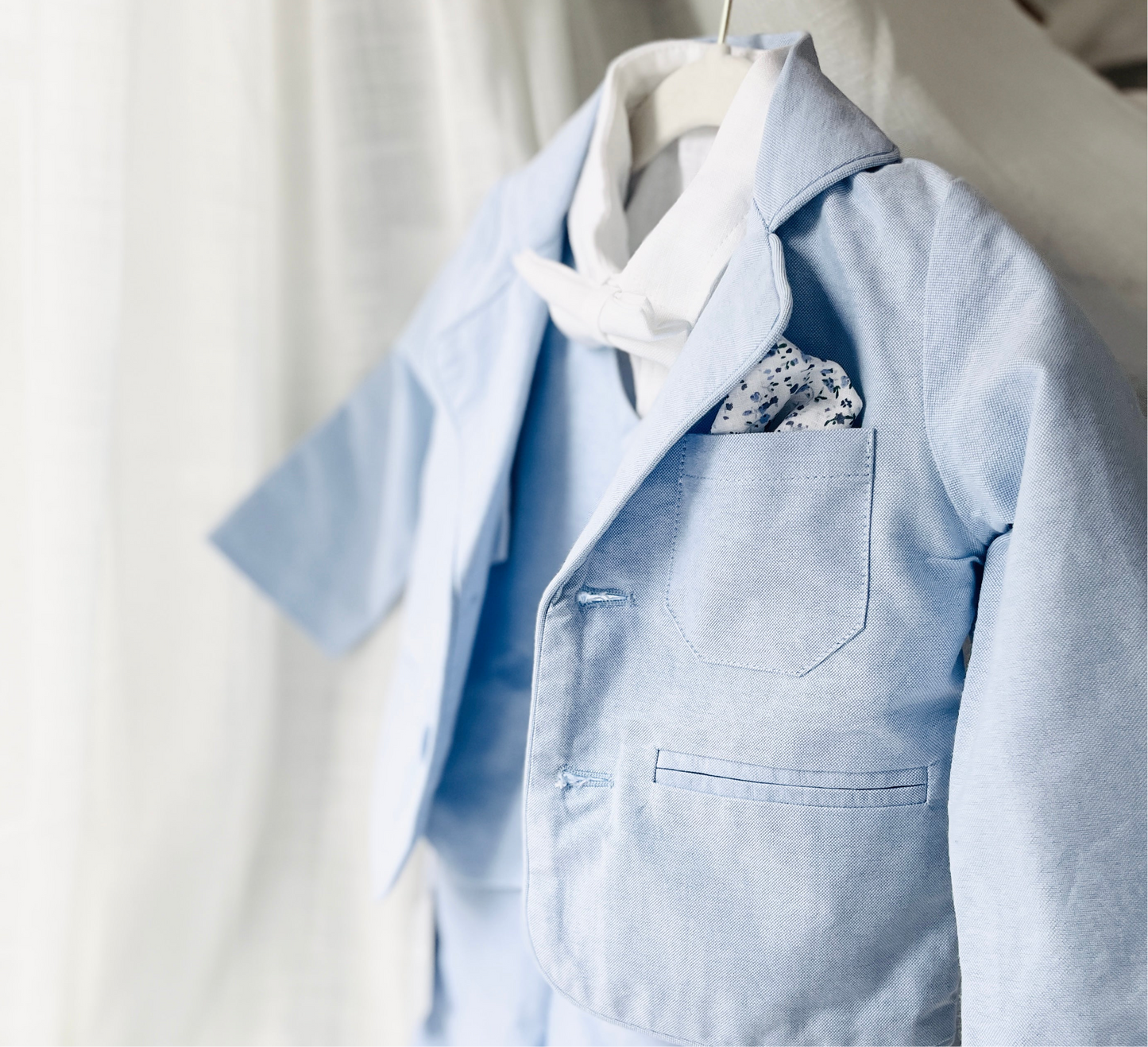 Light blue and white suit set with blue vest, bow tie and jacket, white linen pants, suspenders and shirt