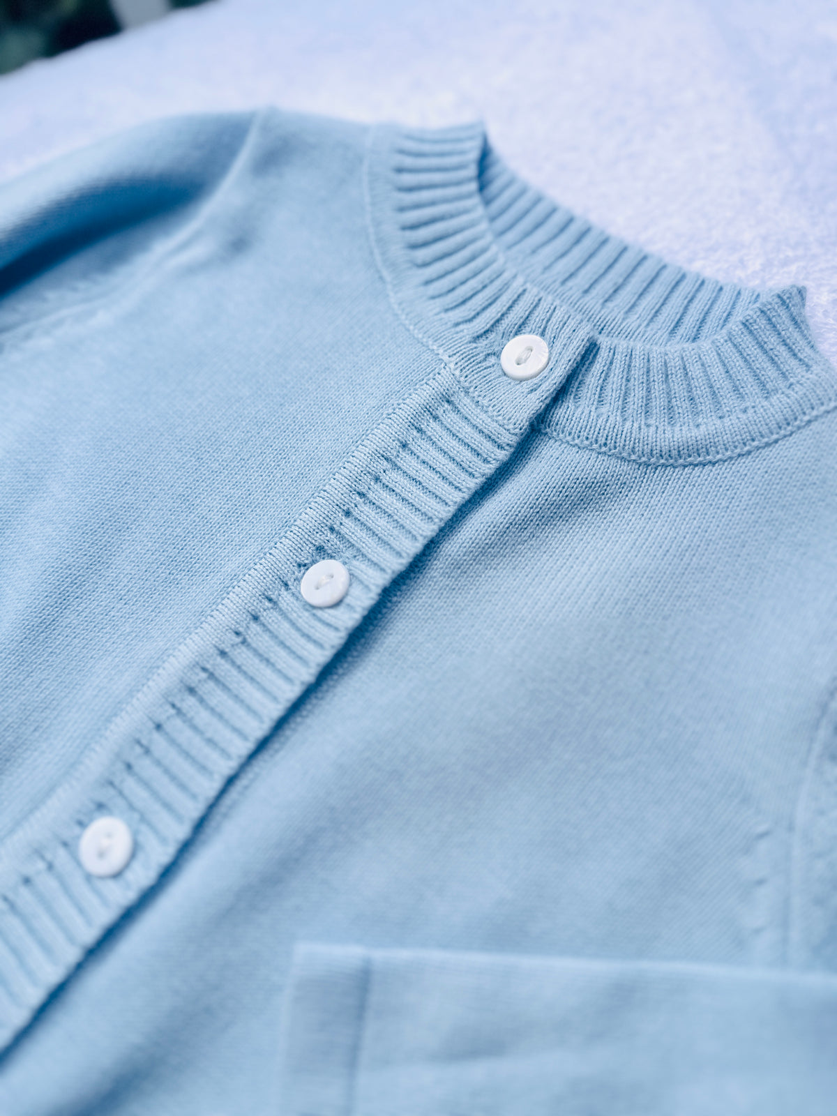 Baby outfit with blue cardigan, round collar bodysuit and white linen bloomers and long socks