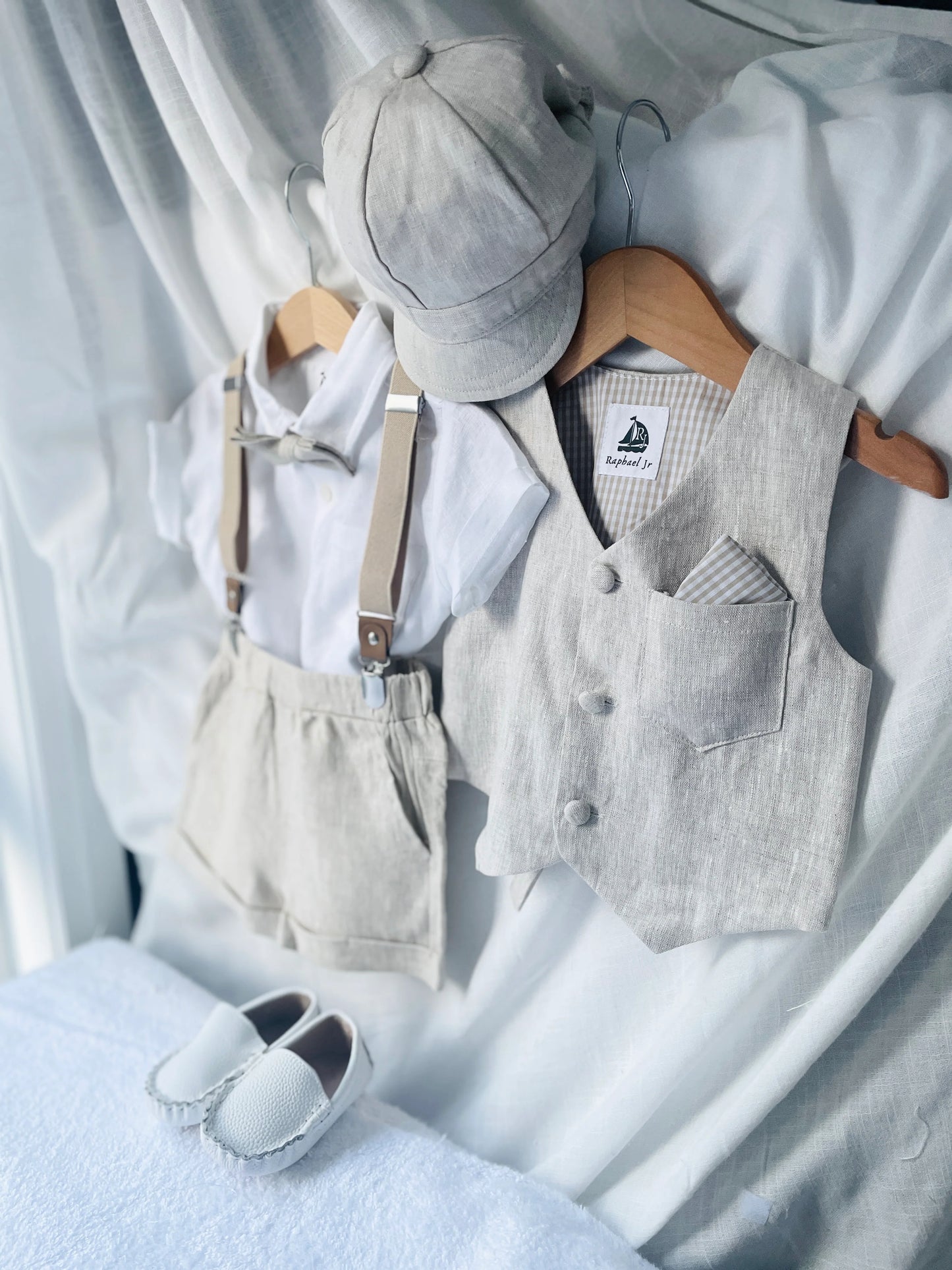 Children's clothing set with shirt, vest, shorts, and shoes on a white background