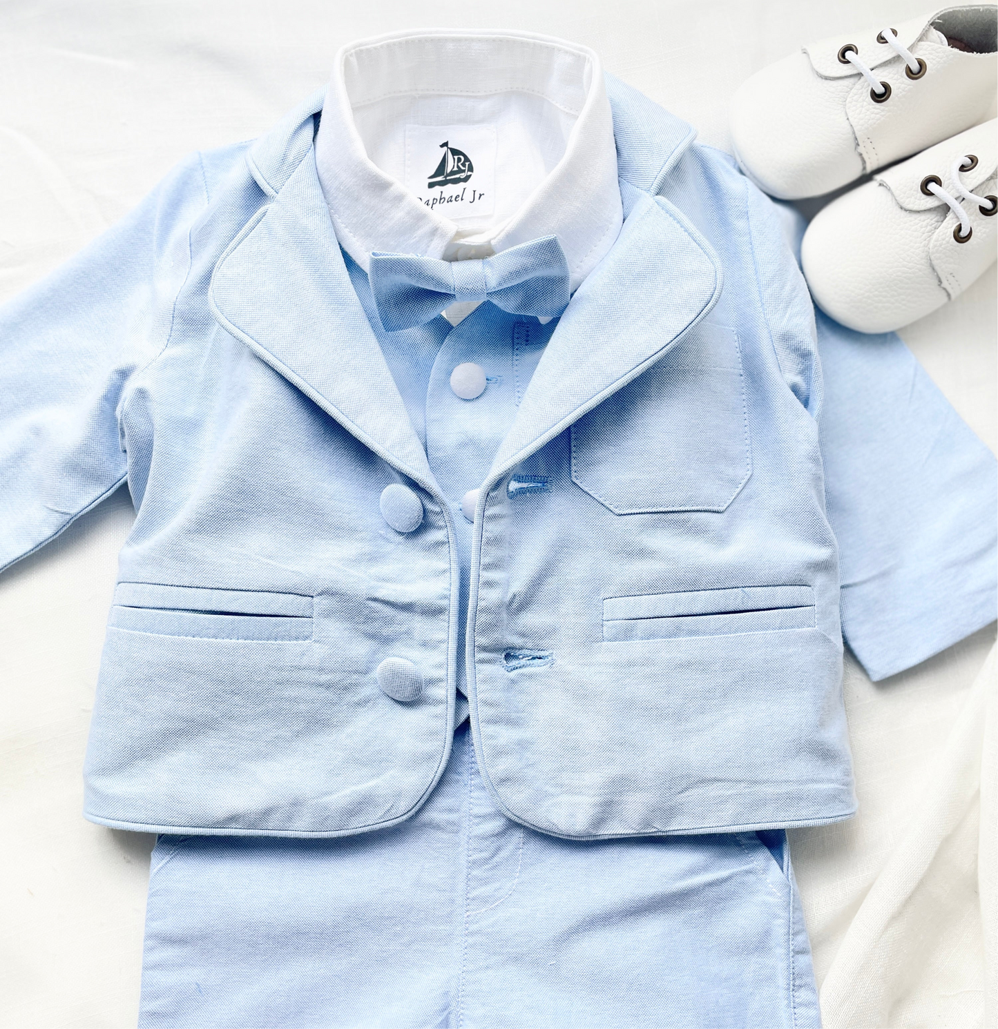 Baby and Toddler Boys pale blue chambray set with vest, pants, linen shirt, bowtie and suspenders, plus optional jacket cap and shoes