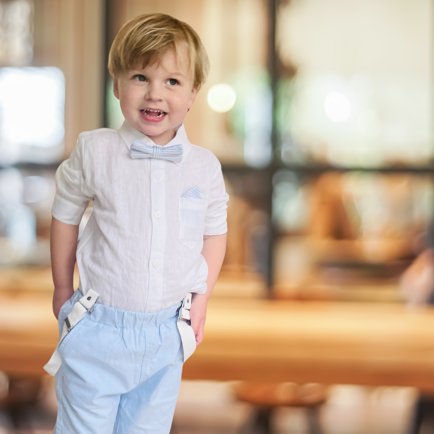 Blue chambray set with blue pants, white linen shirt, white suspenders and blue bowtie