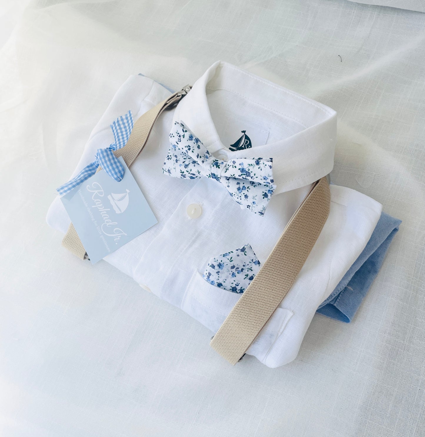 Blue chambray set with blue pants, white linen shirt, white suspenders and blue bowtie