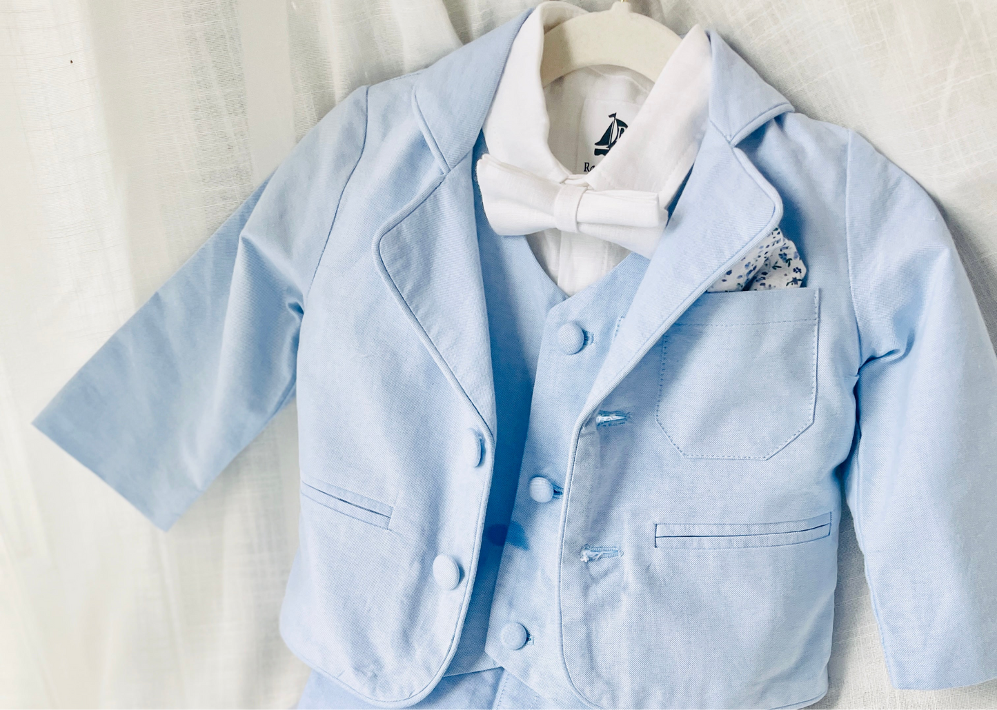 Light blue and white suit set with blue vest, bow tie and jacket, white linen pants, suspenders and shirt