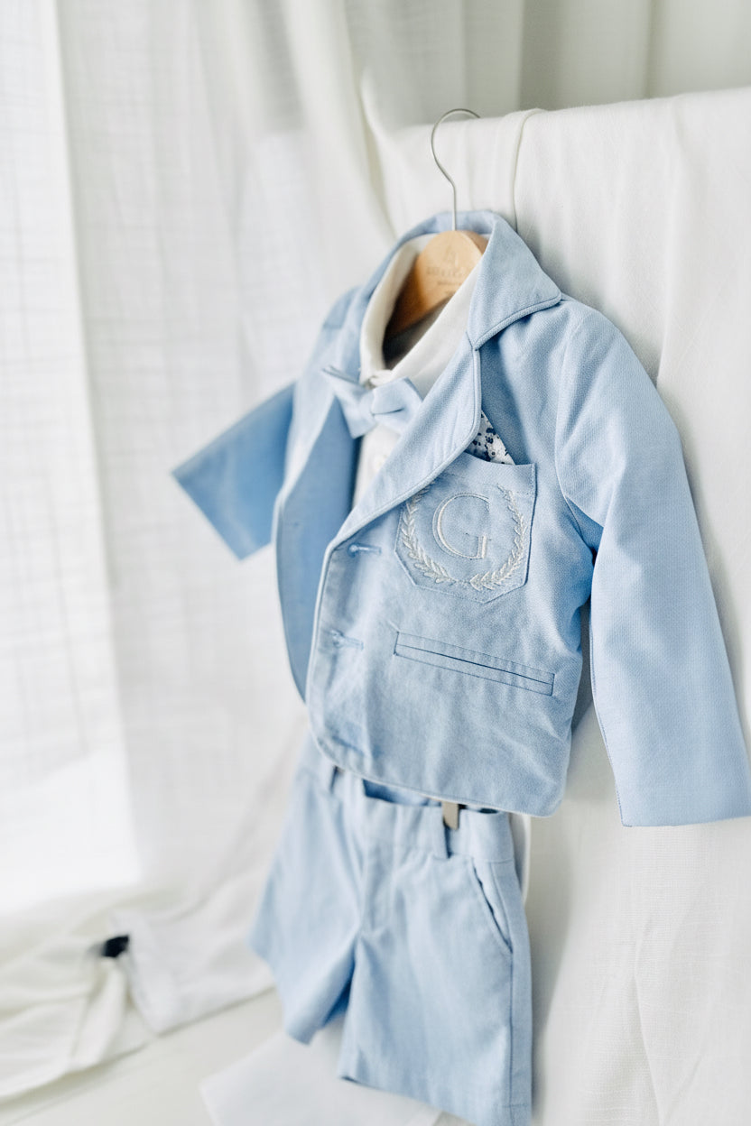 Boys pale blue shorts with linen shirt, blue suspenders and bow tie outfit plus optional extras