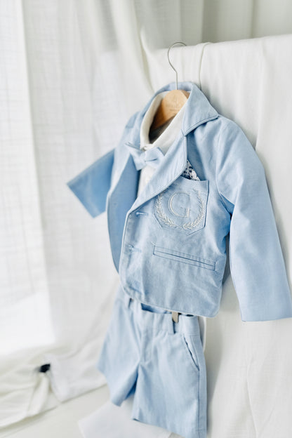 Boys pale blue shorts with linen shirt, blue suspenders and bow tie outfit plus optional extras