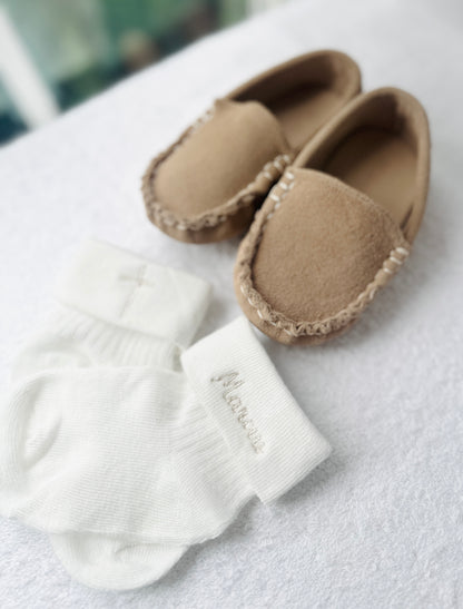 Beige Linen outfit with shorts, socks, shirt, and bow tie plus sweater