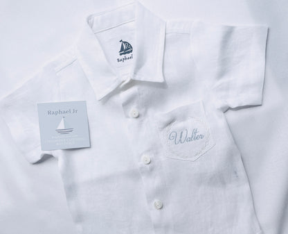 walter written in pale blue thread with white border style number 1 on a short sleeved shirt