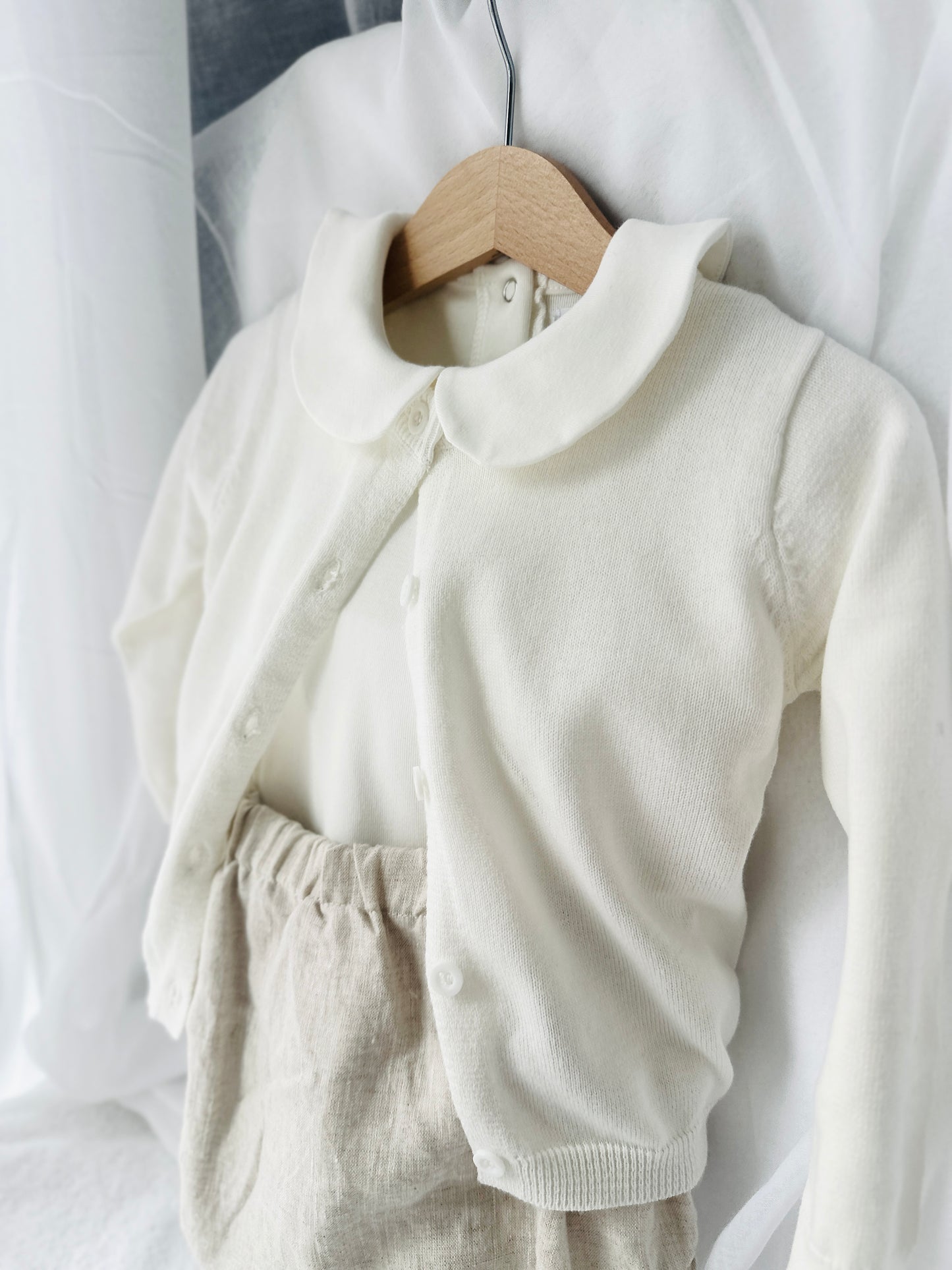 Baptism outfit with cotton onesie and cardigan or jumper and beige linen bloomers and white socks