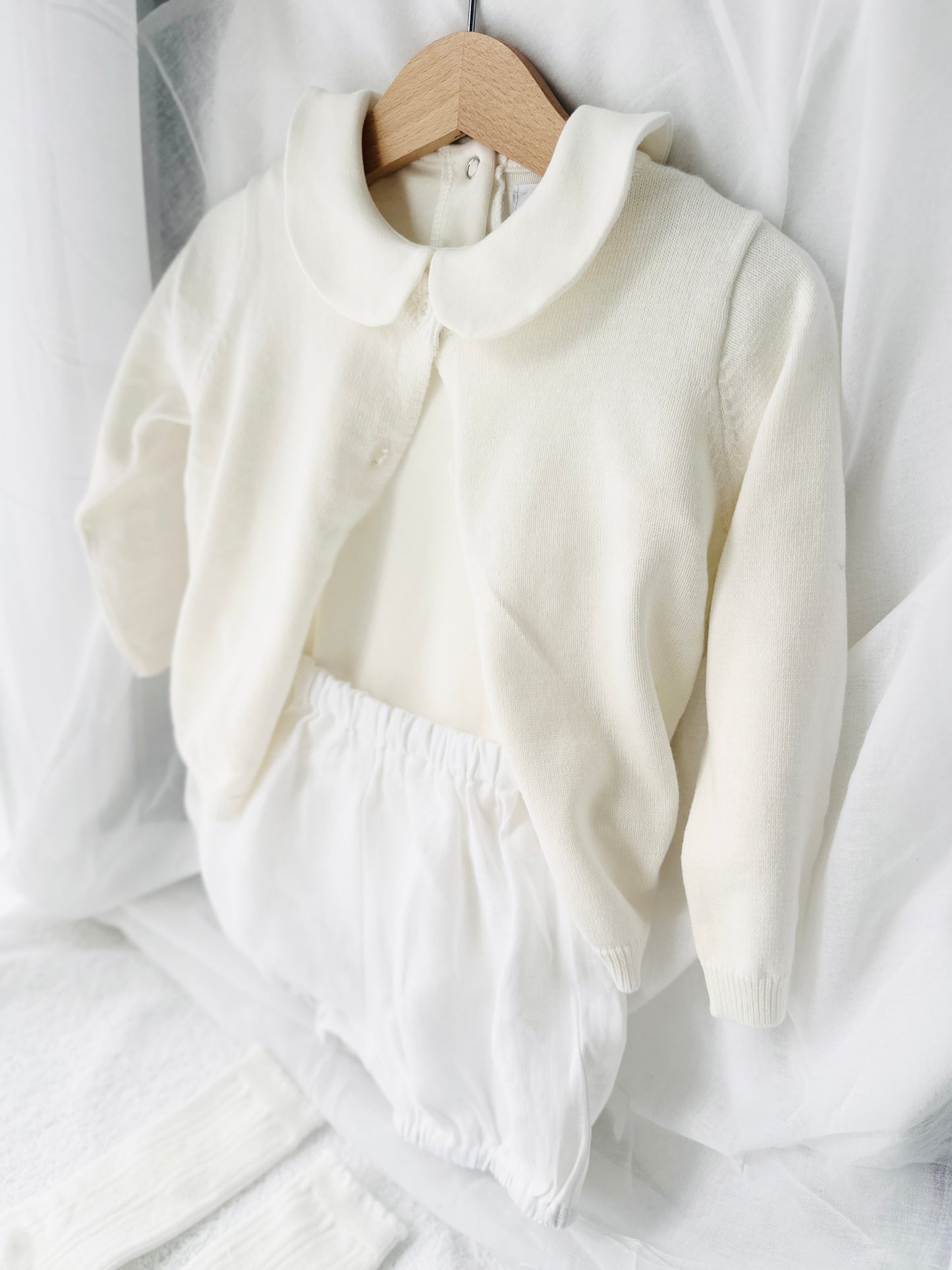 Baptism outfit with cotton onesie and cardigan or jumper and beige linen bloomers and white socks