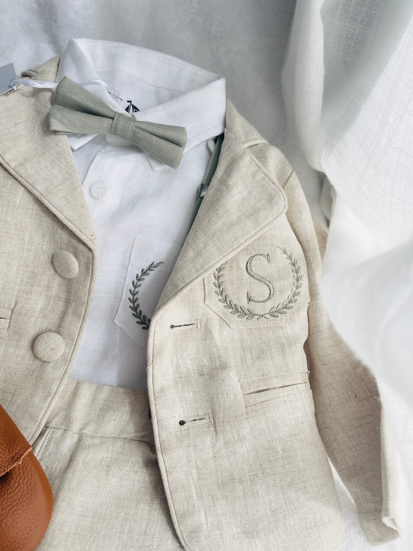 Beige linen suit with optional jacket, cap and shoes.