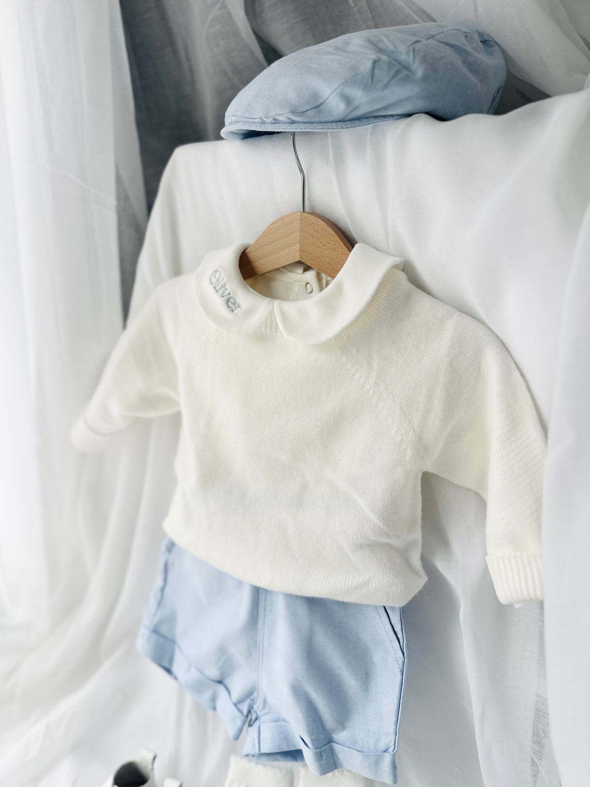 Baptism outfit with cotton onesie and jumper and pale blue shorts and long socks