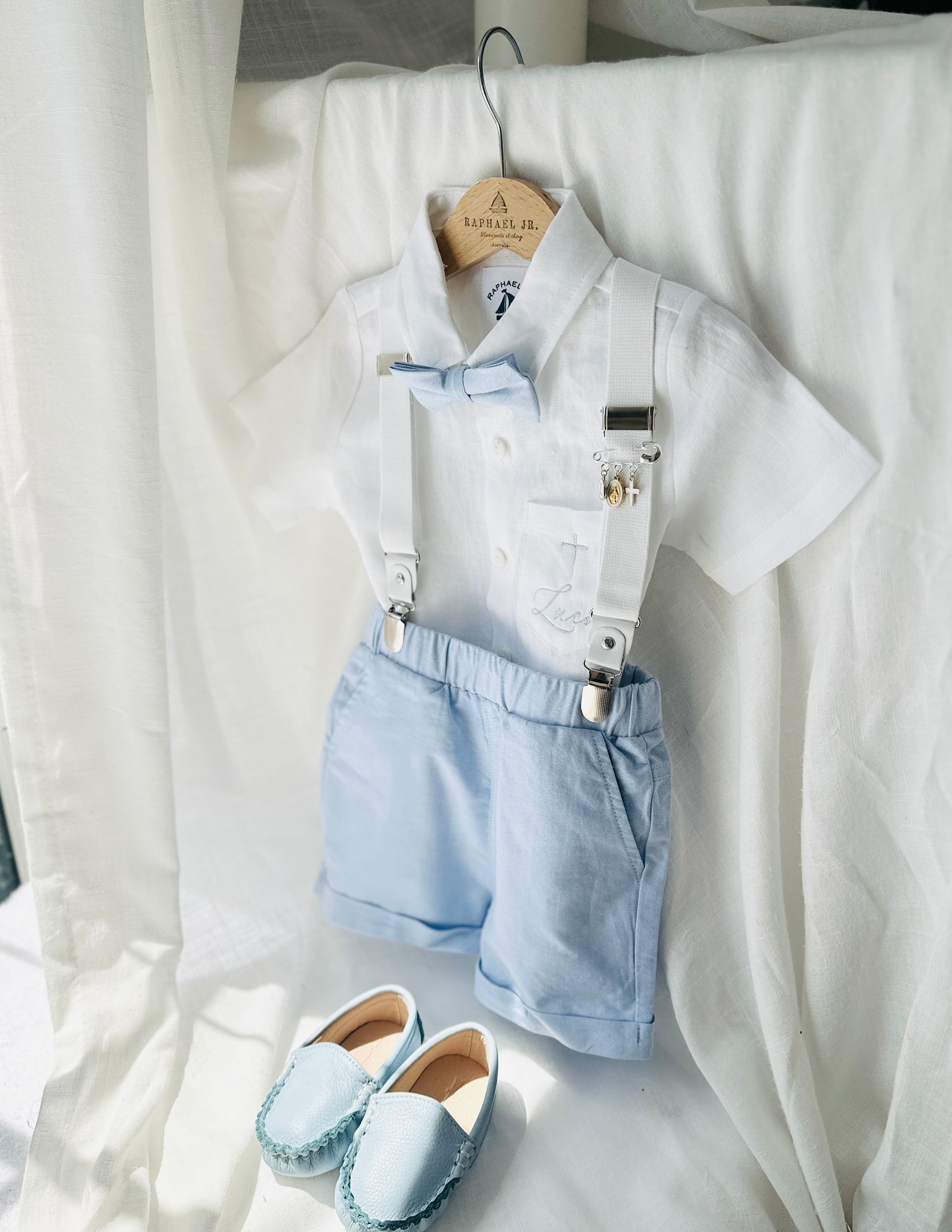 Boys pale blue shorts with linen shirt, blue suspenders and bow tie outfit plus optional extras