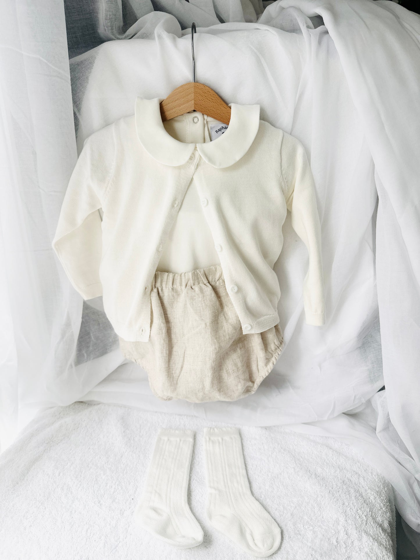 Baptism outfit with cotton onesie and cardigan or jumper and beige linen bloomers and white socks