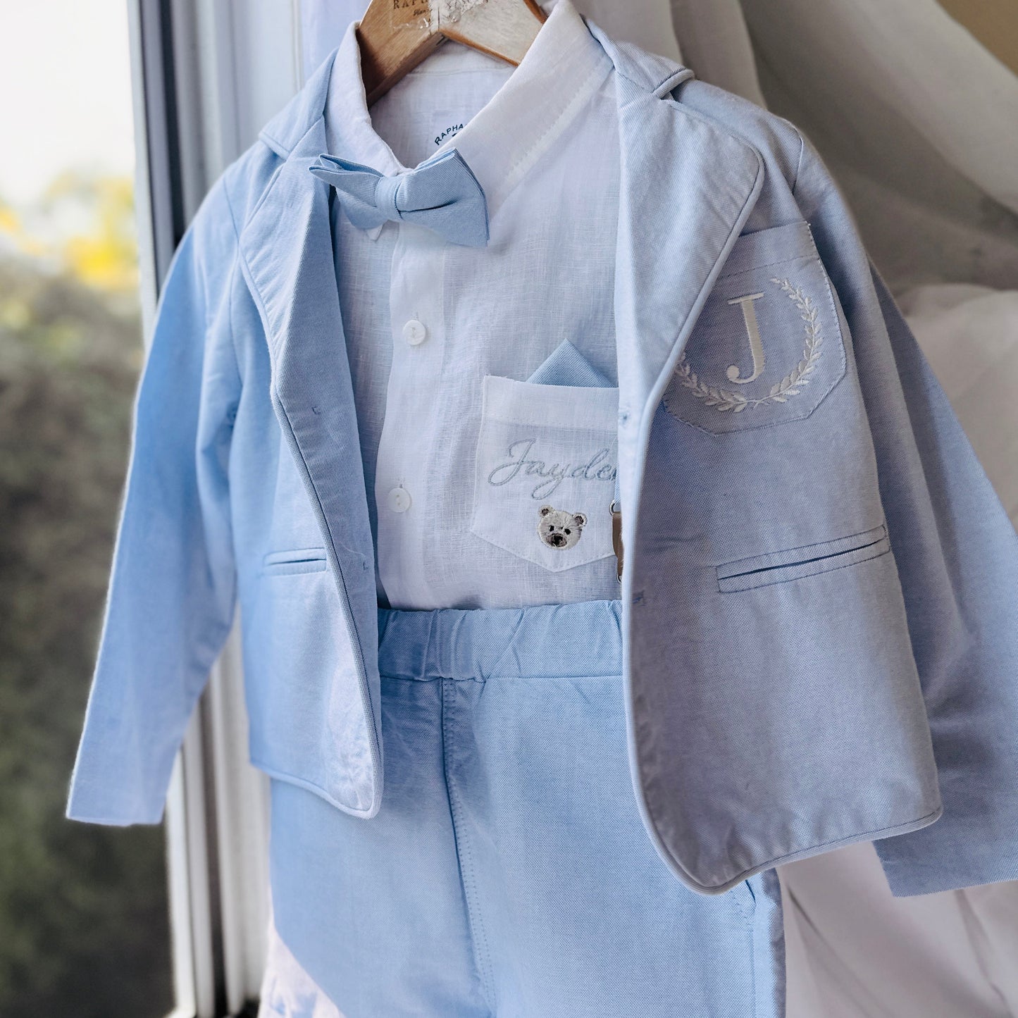 Boys pale blue shorts with linen shirt, blue suspenders and bow tie outfit plus optional extras
