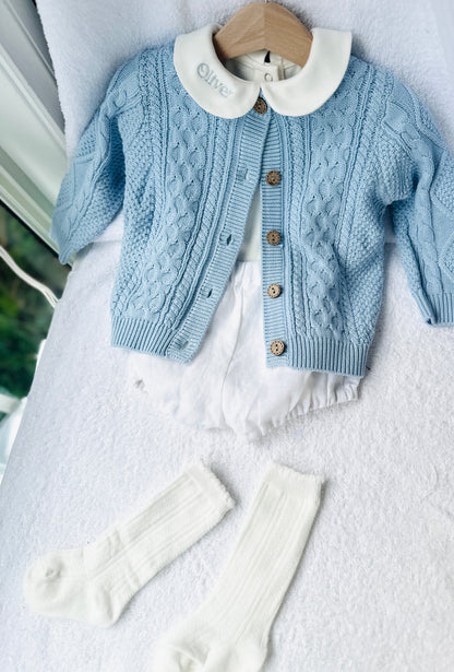 Baby outfit with blue cardigan, round collar bodysuit and white linen bloomers and long socks
