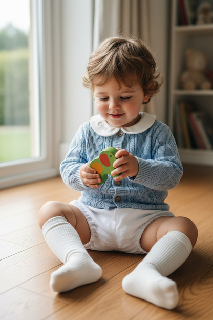 Baby outfit with blue cardigan, round collar bodysuit and white linen bloomers and long socks