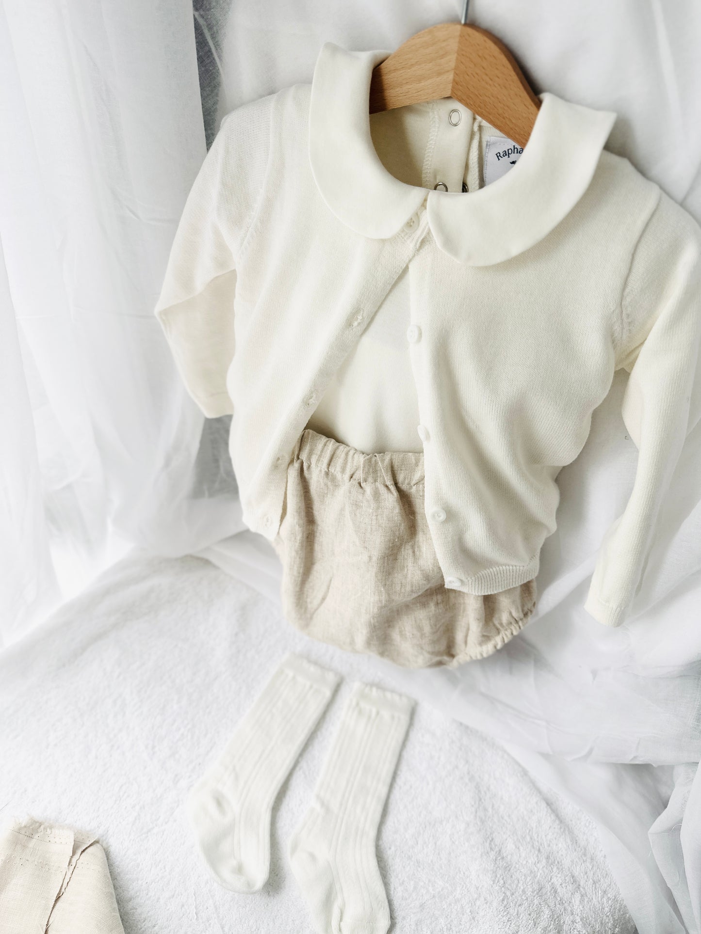 Baptism outfit with cotton onesie and cardigan or jumper and beige linen bloomers and white socks