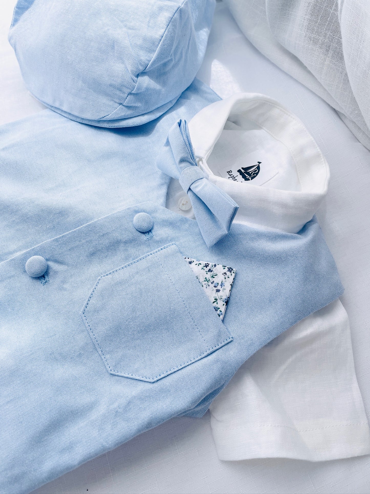 Light blue and white suit set with blue vest, bow tie and jacket, white linen pants, suspenders and shirt