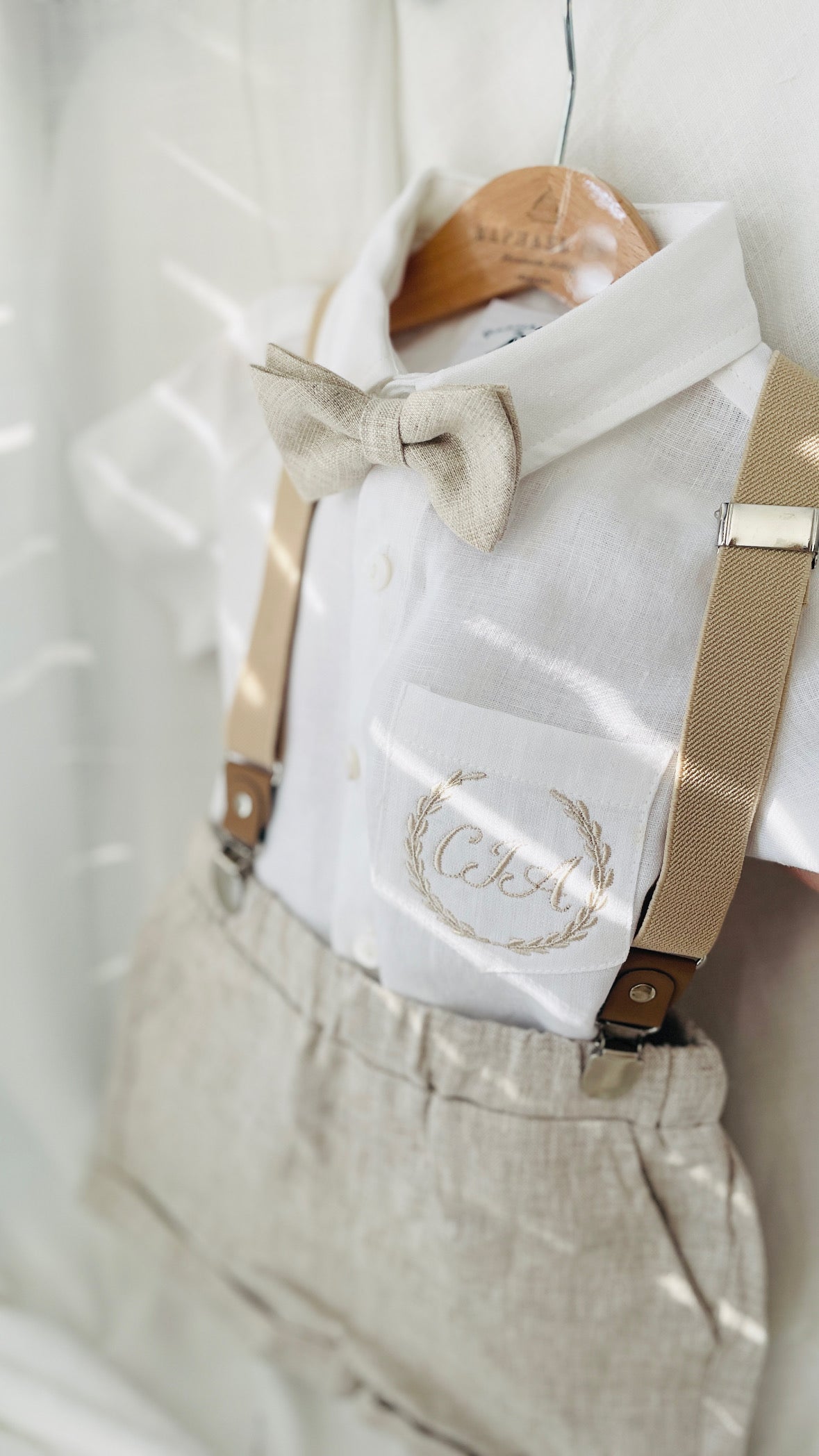 Beige Linen Baptism outfit with suspender shorts, shirt, and bow tie plus optional jacket and embroidery
