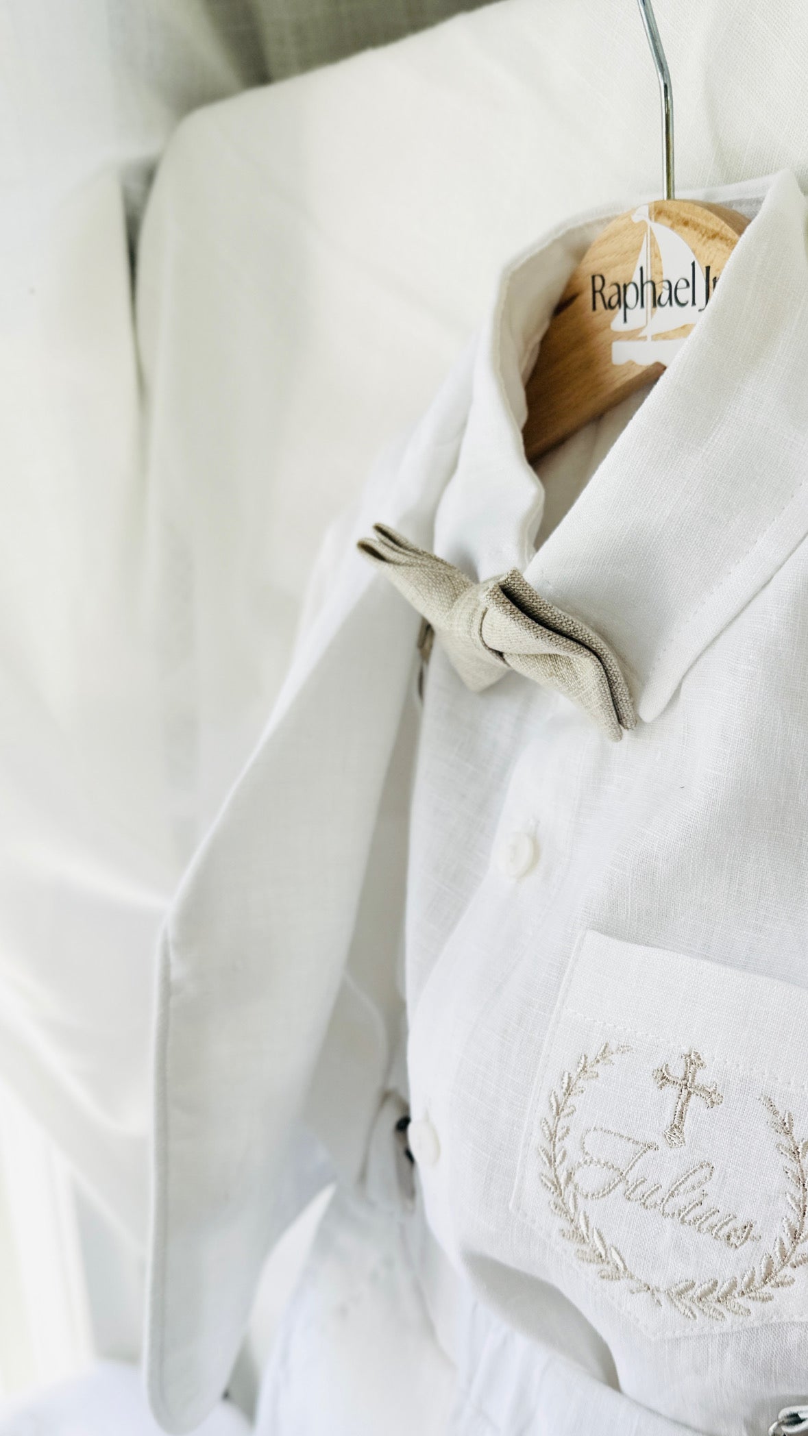 White linen shirt and shorts and jacket Baptism suit with a beige bowtie and beige embroidered pocket and white suspenders
for a baby boy with leather loafers by Raphael Jr 