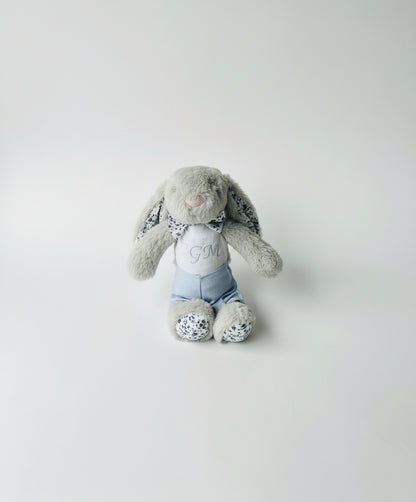 great bunny toy dressed in white linen and blue jacket with embroidered belly
