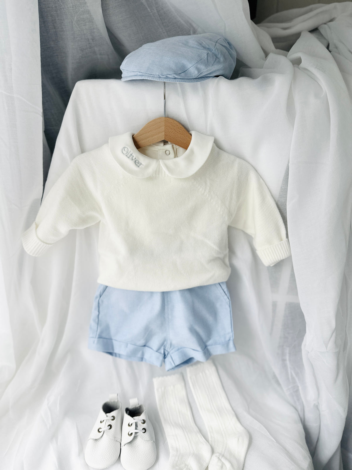 Baptism outfit with cotton onesie and jumper and pale blue shorts and long socks