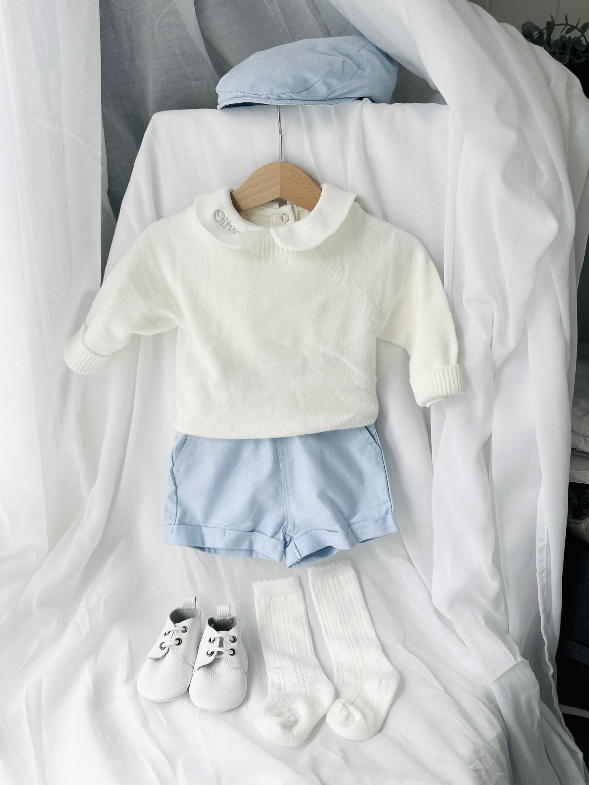 Baptism outfit with cotton onesie and jumper and pale blue shorts and long socks