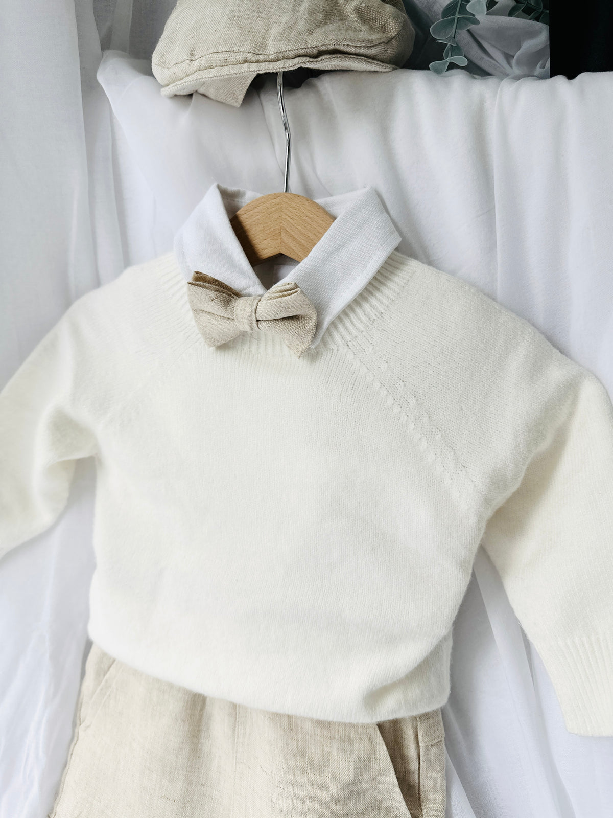 Beige Linen outfit with shorts, socks, shirt, and bow tie plus sweater
