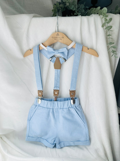 Boys pale blue shorts with linen shirt, blue suspenders and bow tie outfit plus optional extras