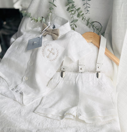 White linen shirt and shorts Baptism suit with a beige bowtie and beige embroidered pocket with a cross and white suspenders
for a baby boy Raphael Jr 