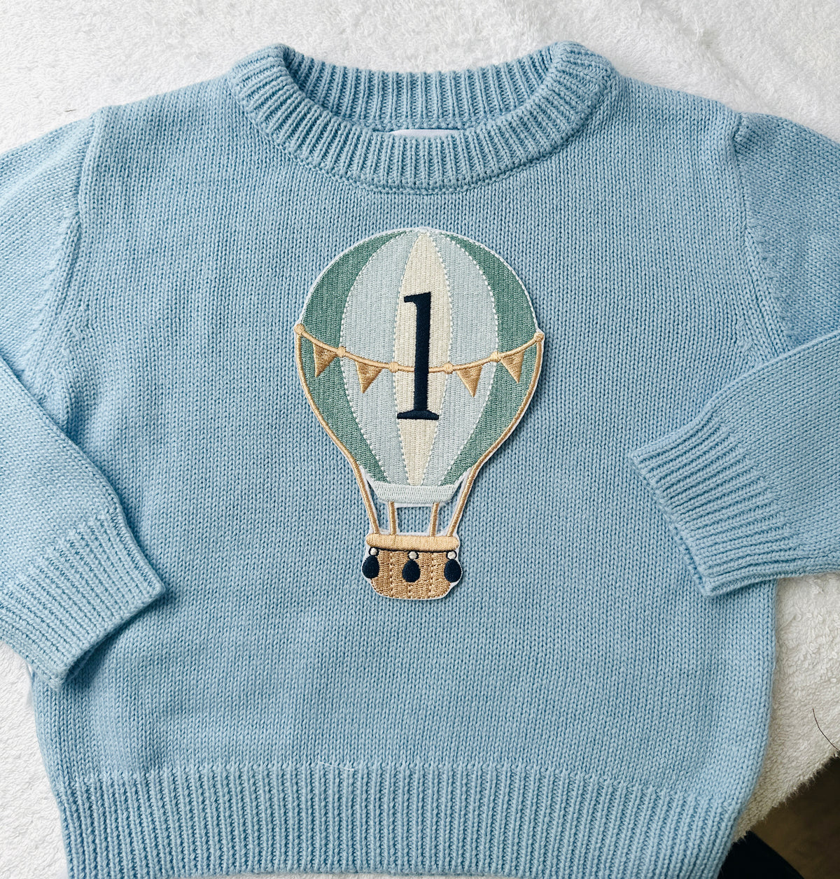 Pale blue teddy or hot air balloon jumper knit