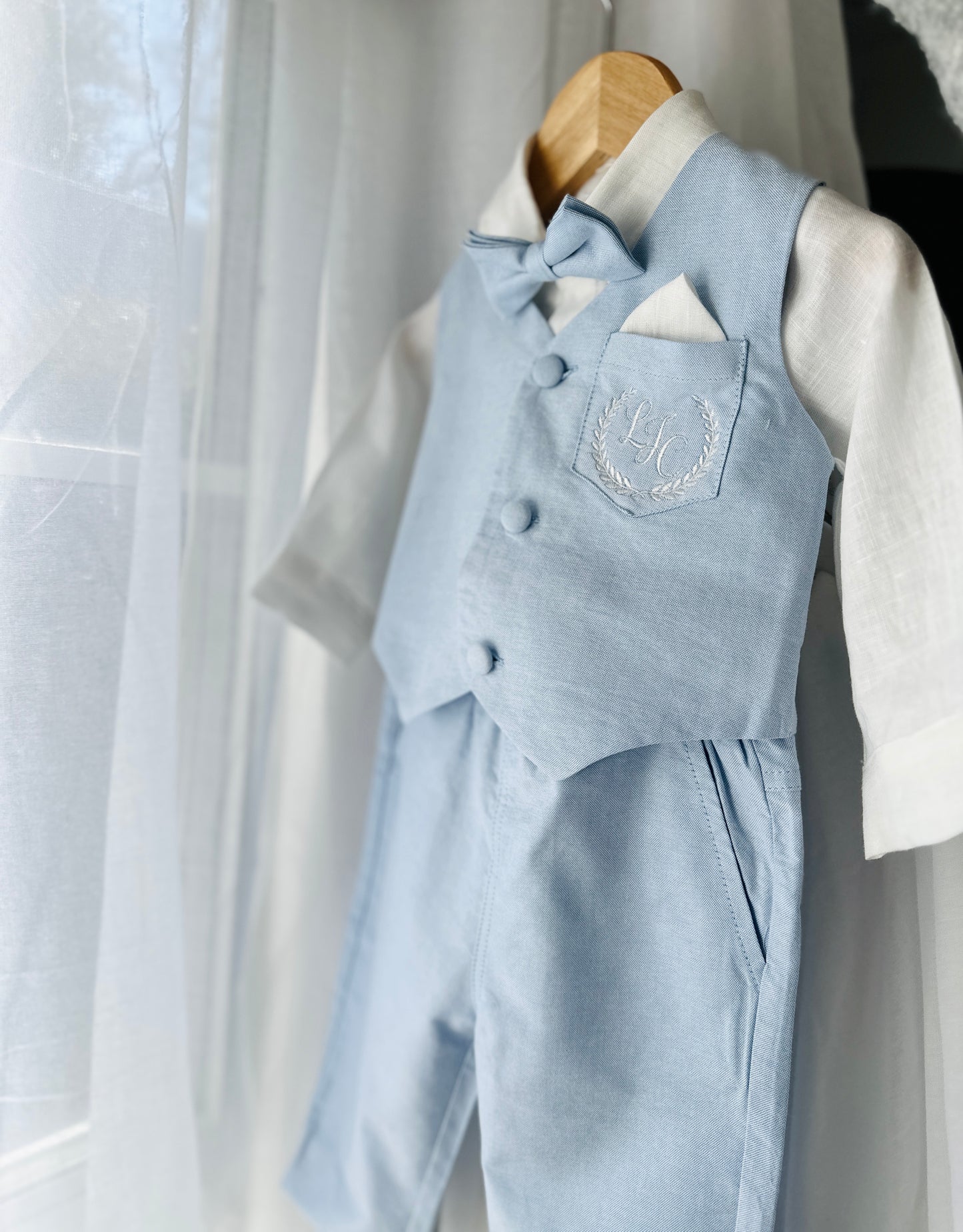 Pale blue summer vest set with blue vest, suspender shorts white shirt and bowtie