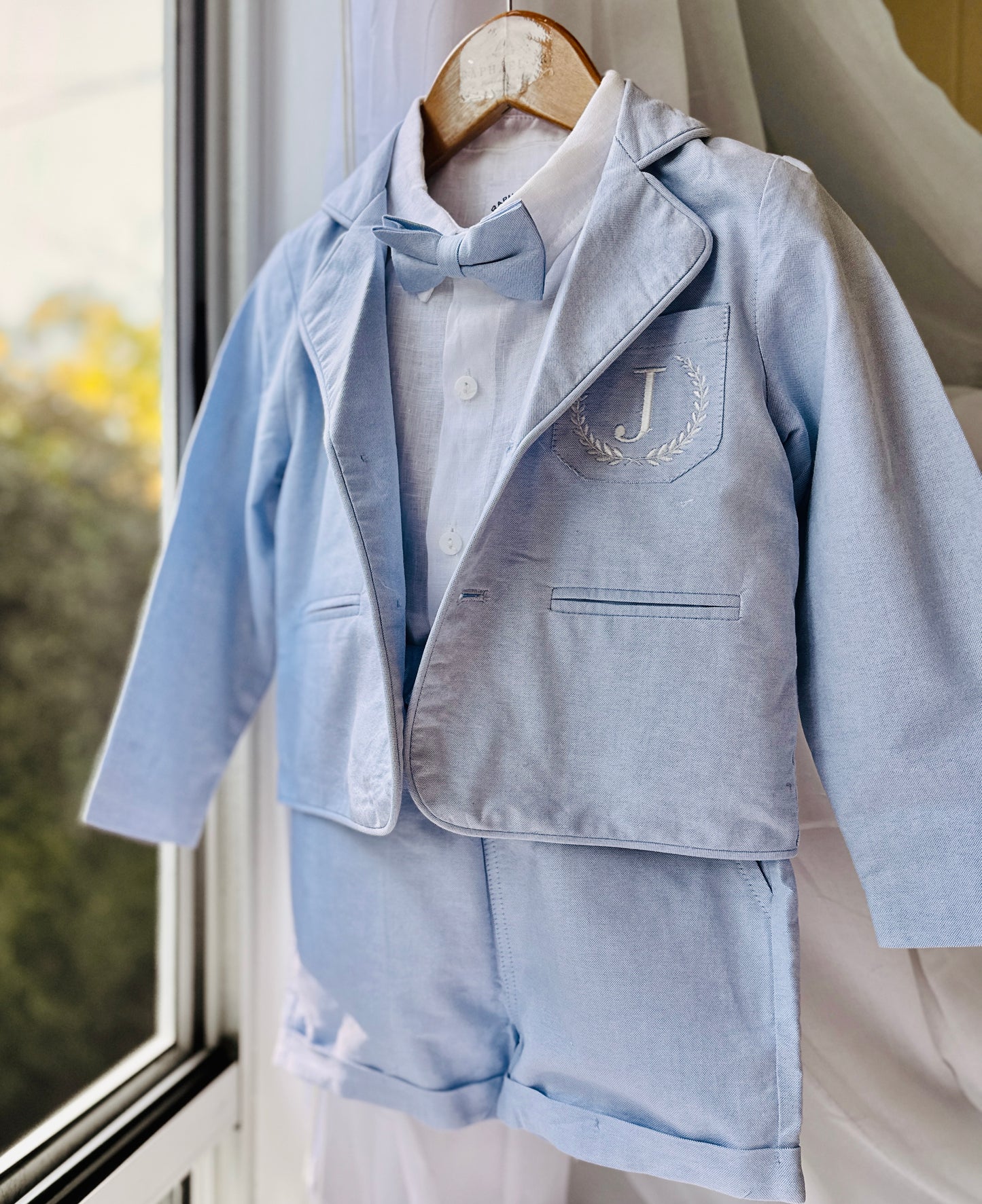 Boys pale blue shorts with linen shirt, blue suspenders and bow tie outfit plus optional extras