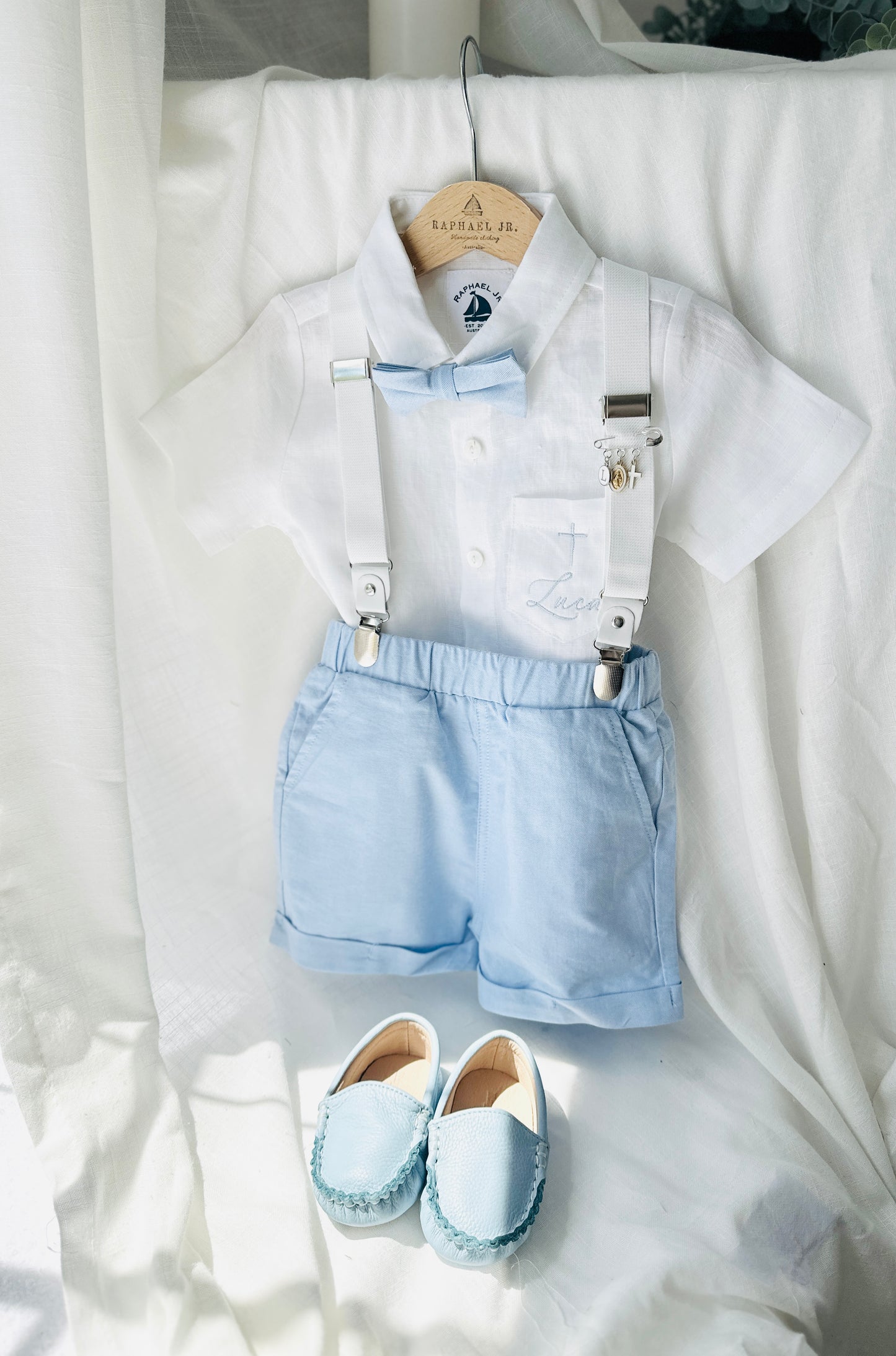 Boys pale blue shorts with linen shirt, blue suspenders and bow tie outfit plus optional extras