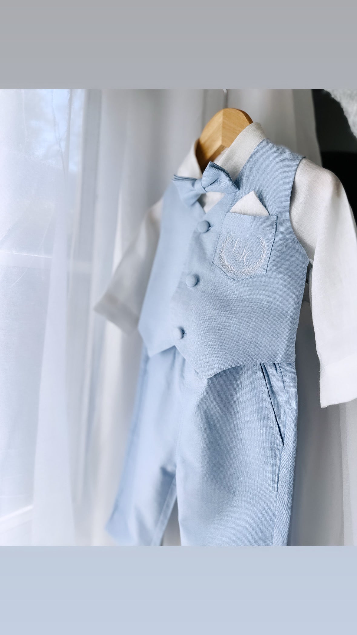 Pale blue vest suit with white pants and blue vest