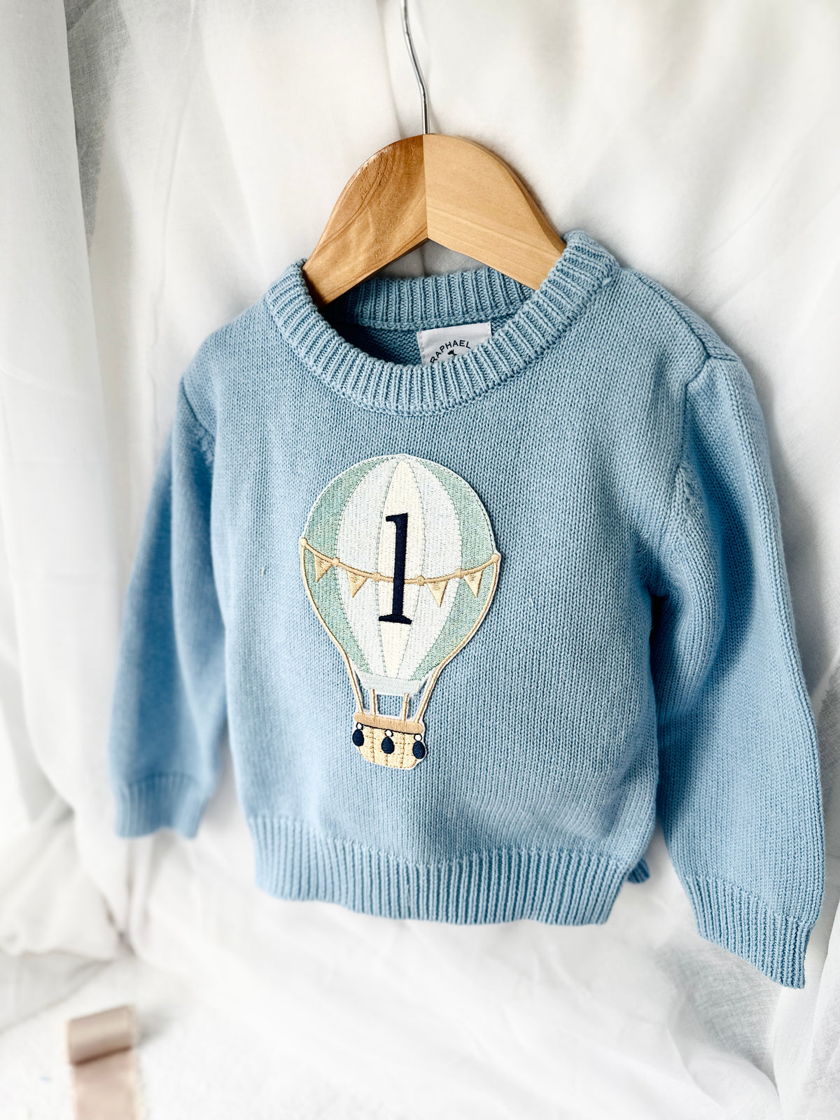 Pale blue teddy or hot air balloon jumper knit